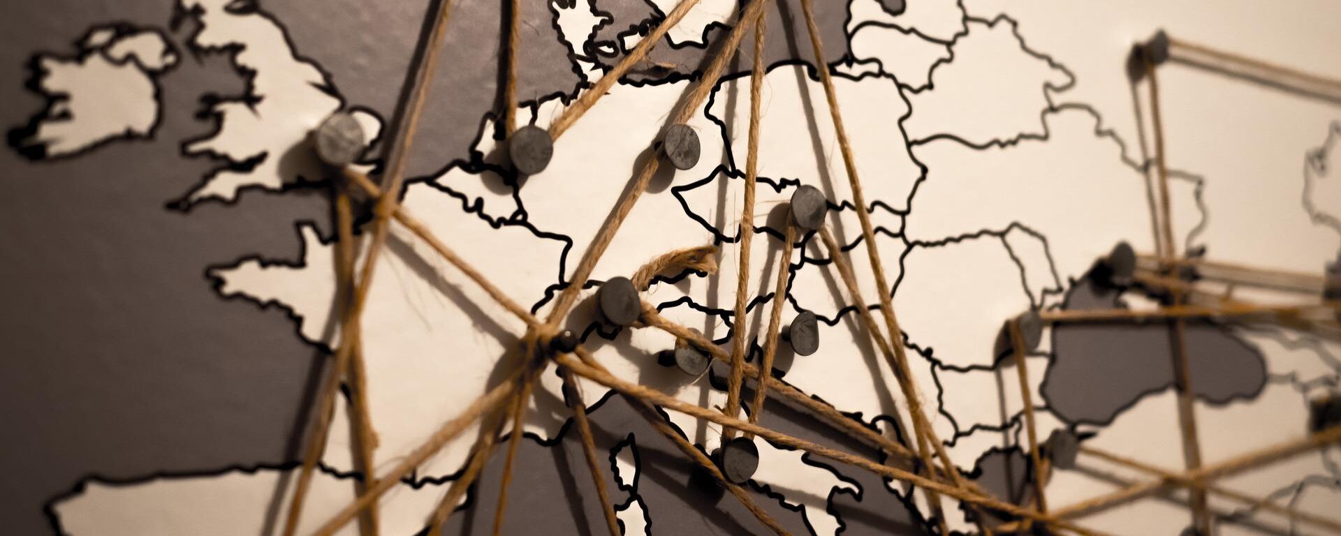 A map of Europe with pins and string